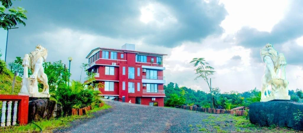 the resort in Karjat for family vacations, surrounded by lush greenery and scenic mountain views.