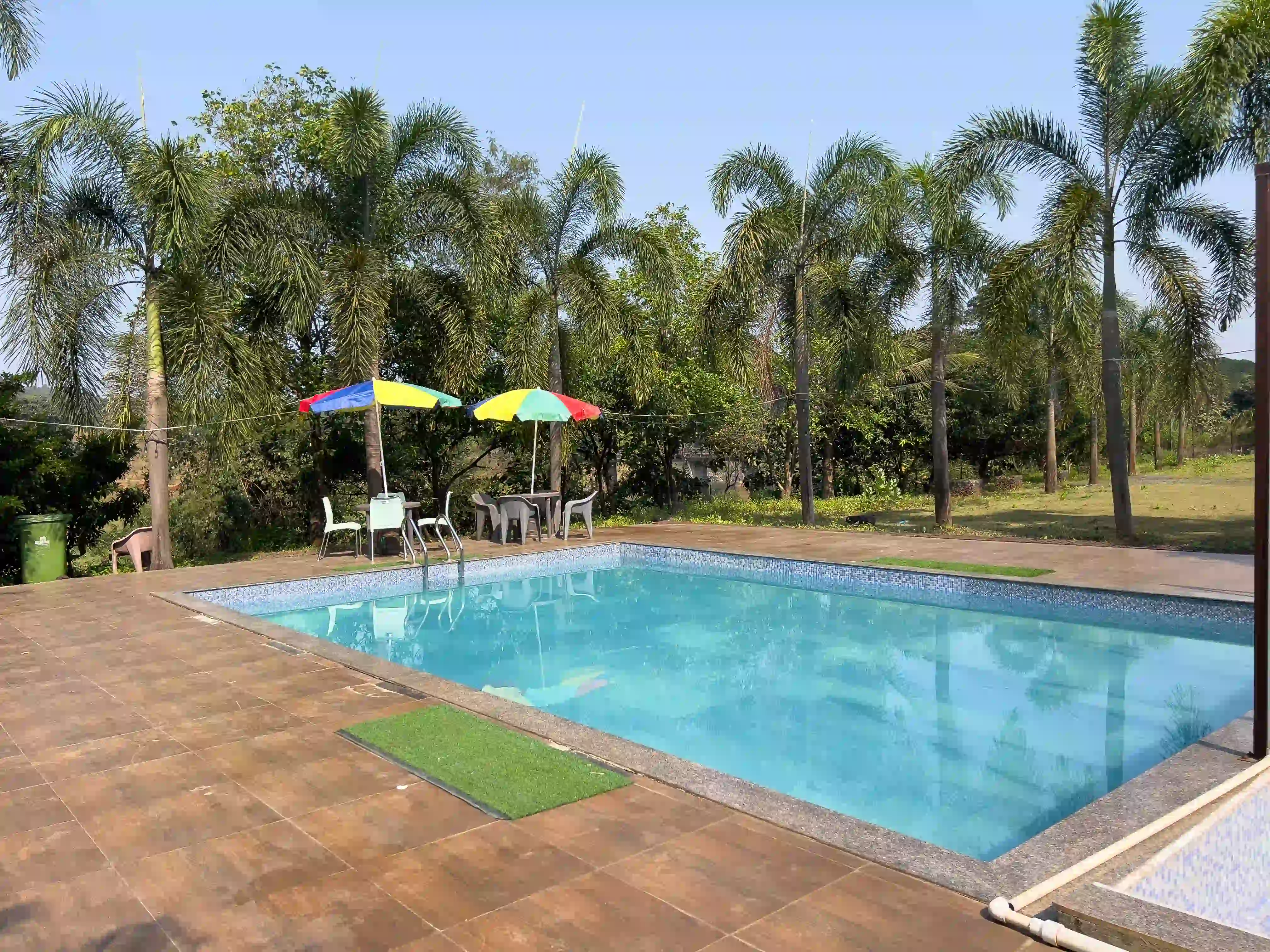 the resort in Karjat for family vacations, surrounded by lush greenery and scenic mountain views.